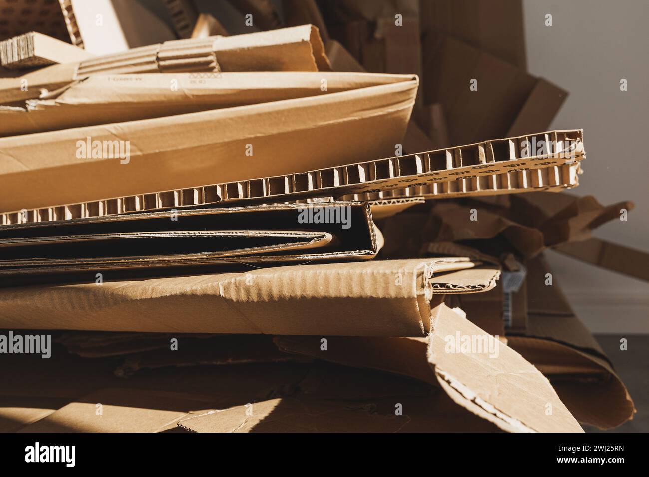 Stack of Cardboard Waste in sunlight. Concepts of Paper Recycling and Waste Sorting Stock Photo