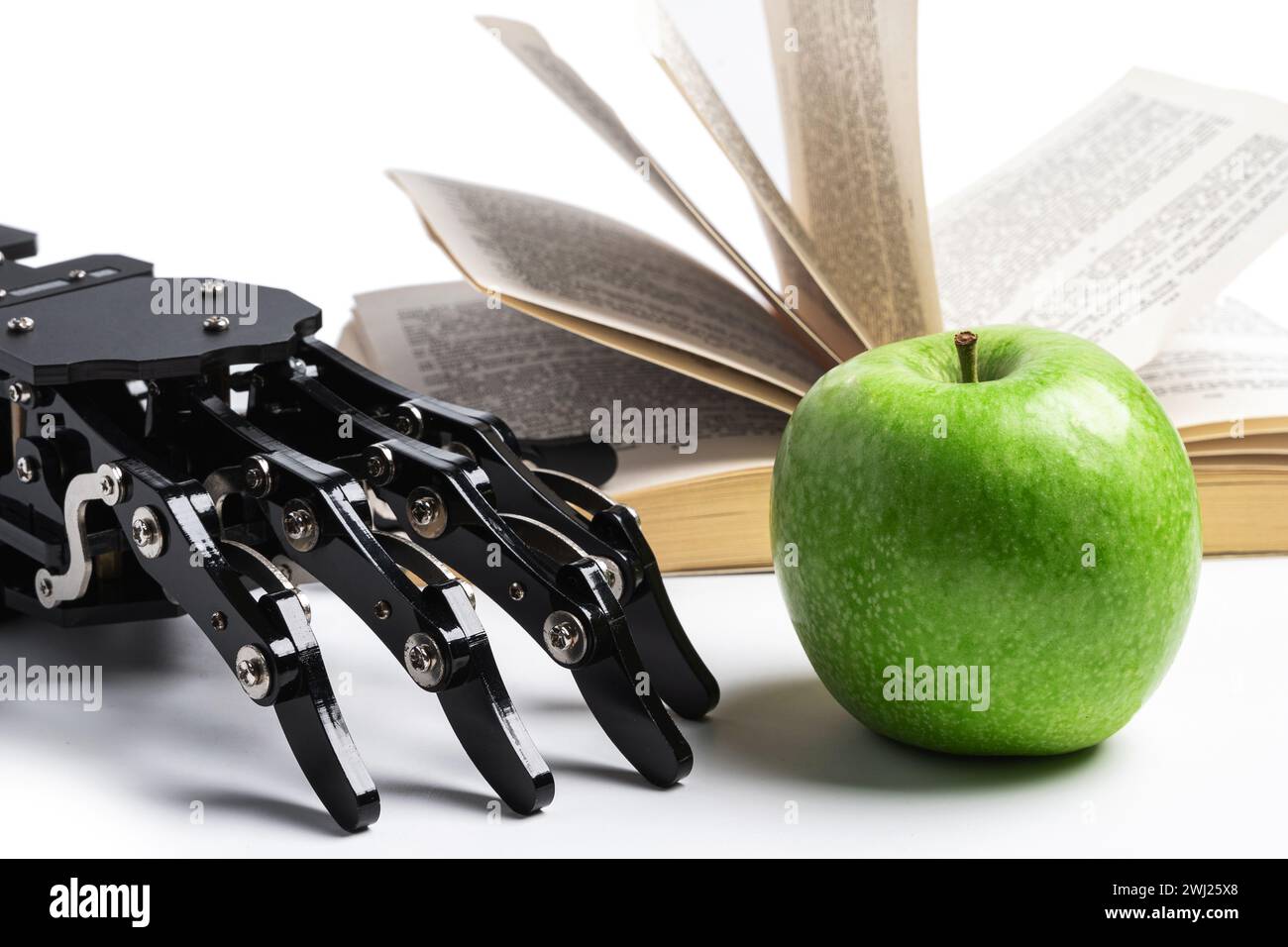Real robotic hand and opened book. Concept of AI power and machine learning Stock Photo