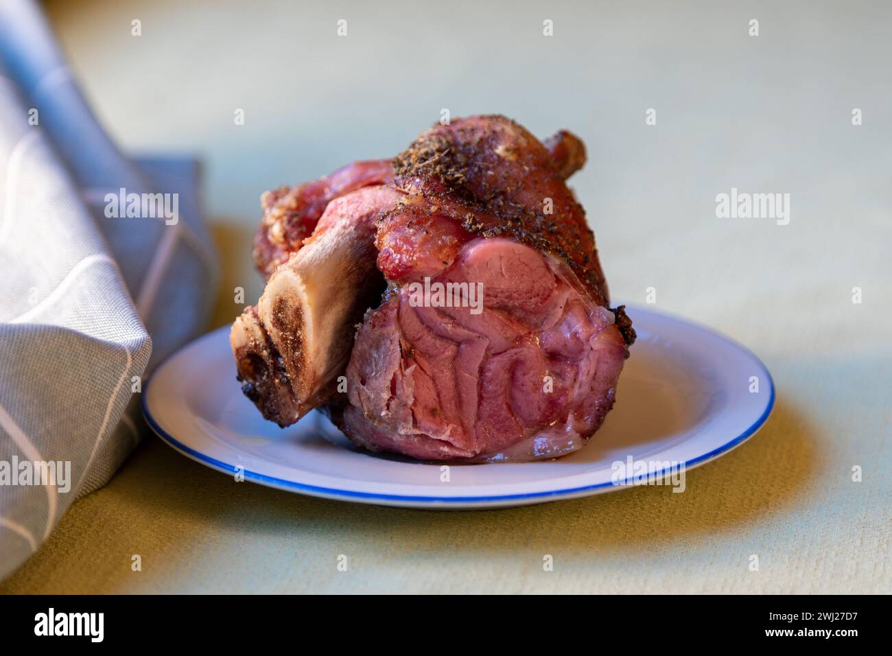 Knuckle of pork on a small plate Stock Photo