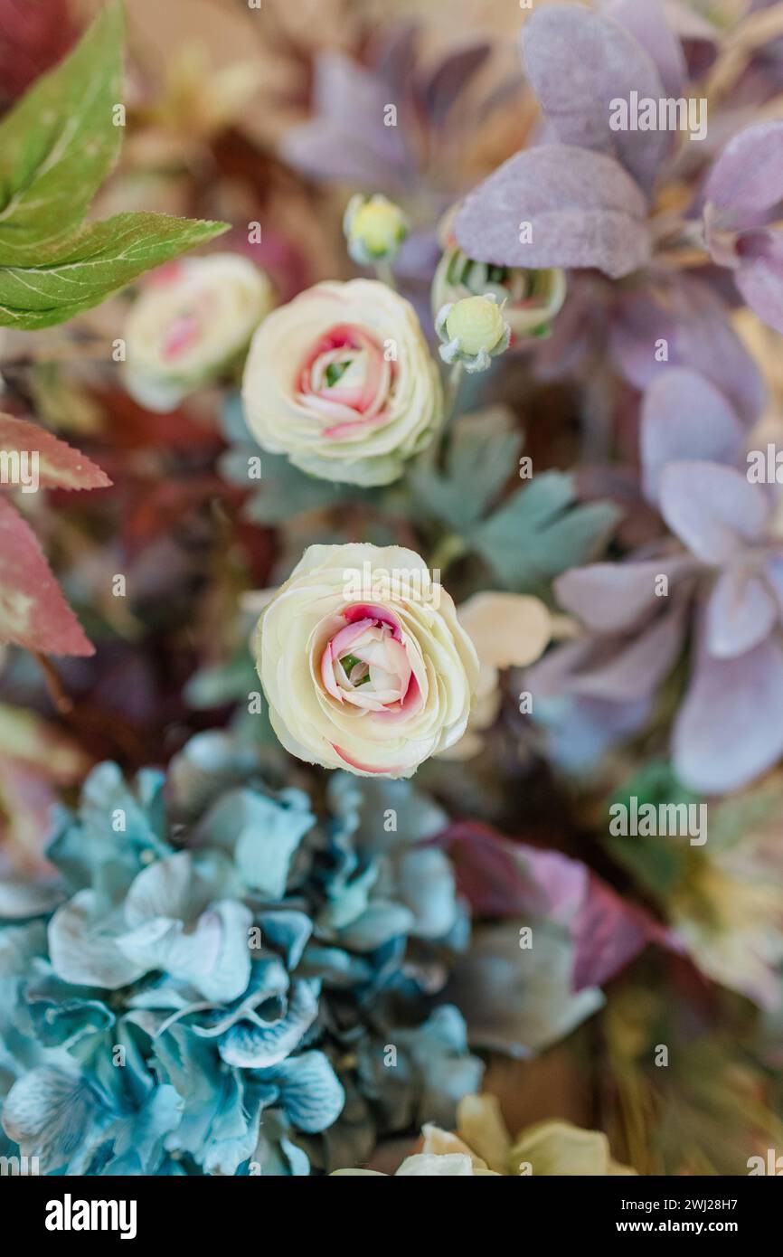 Faux flowers in muted colors with roses and hydrangeas Stock Photo