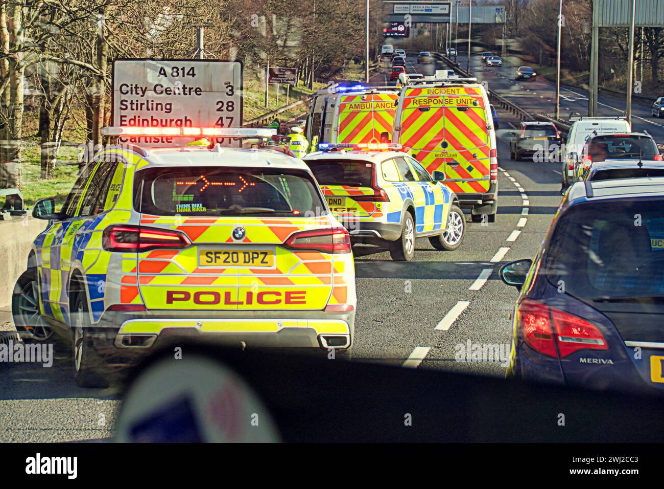 Glasgow, Scotland, UK. 12th February, 2024.Officers say the incident happened at around 1.30pm on Monday, February 12, on the A814 expressway. Following the crash, one person was taken to hospital.  Large car accident response saw multiple police cars and ambulances attend an incident on the clydeside expressway near Partick. Credit Gerard Ferry/Alamy Live News Stock Photo
