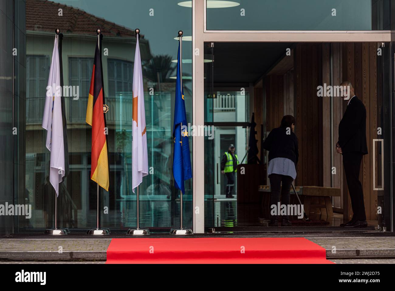 The flags of Cyprus, Germany, EU and Nicosia municipality are seen outside the Town Hall, Nicosia, Cyprus, on Feb. 12, 2024. The President of Germany, Frank-Walter Steinmeier is being guided from President of Cyprus, Nikos Christodoulides and Nicosia Mayor, Constantinos Yiorkadjis to the old city of Nicosia, where the barricades that separate the Greek and Turkish side of the city are visible, also called the 'Green Line'. Nicosia is the last divided European capital. The visit of the German President is the first ever since the establishment of Republic of Cyprus in 1960 and the conclusion of Stock Photo