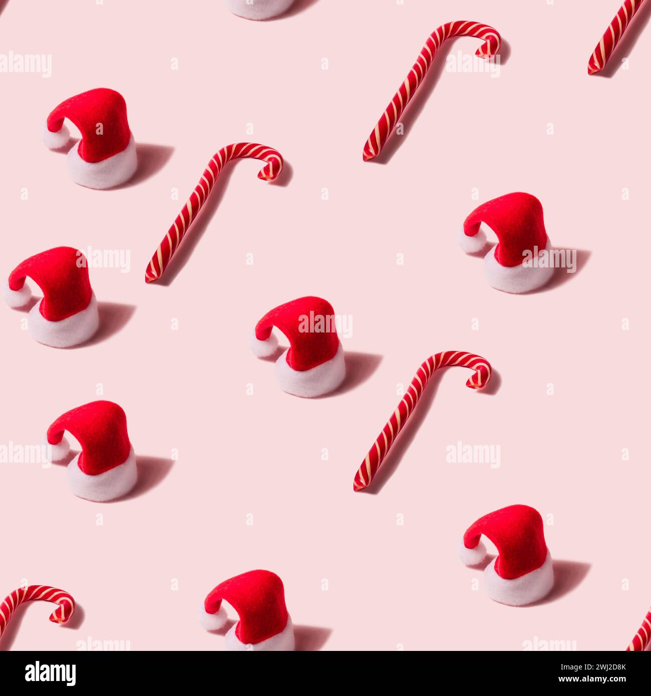 Trendy Christmas seamless random texture with Santa Claus hat and candy cane. Modern christmas design Stock Photo