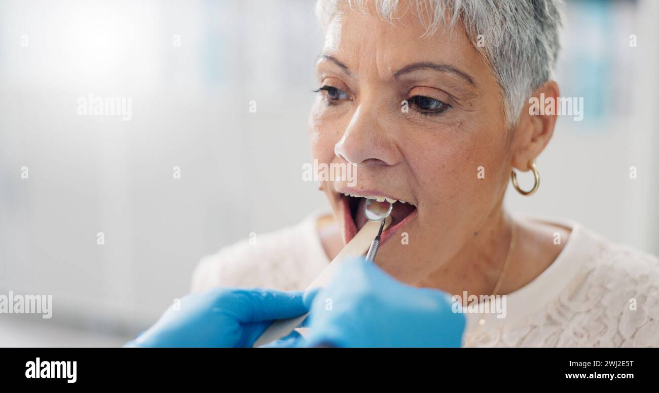 Patient, doctor and tongue depressor for throat assessment in clinic