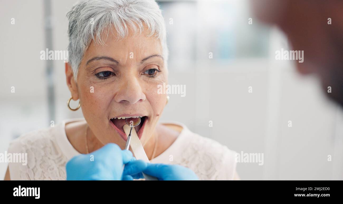 Patient, doctor and tongue depressor for throat assessment in clinic