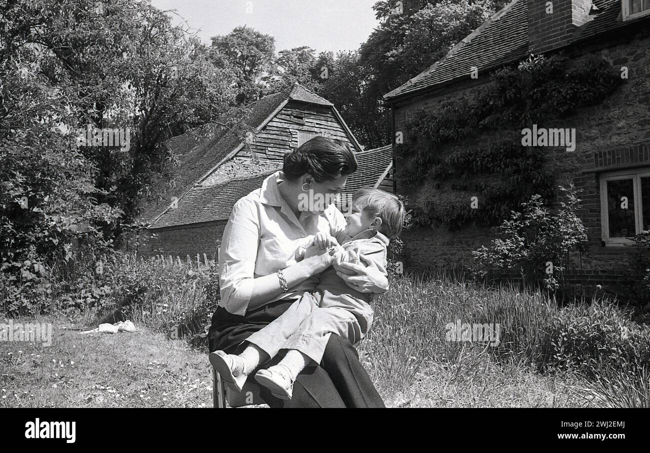 1960s, historical, motherhood, summertime and outside in a country ...