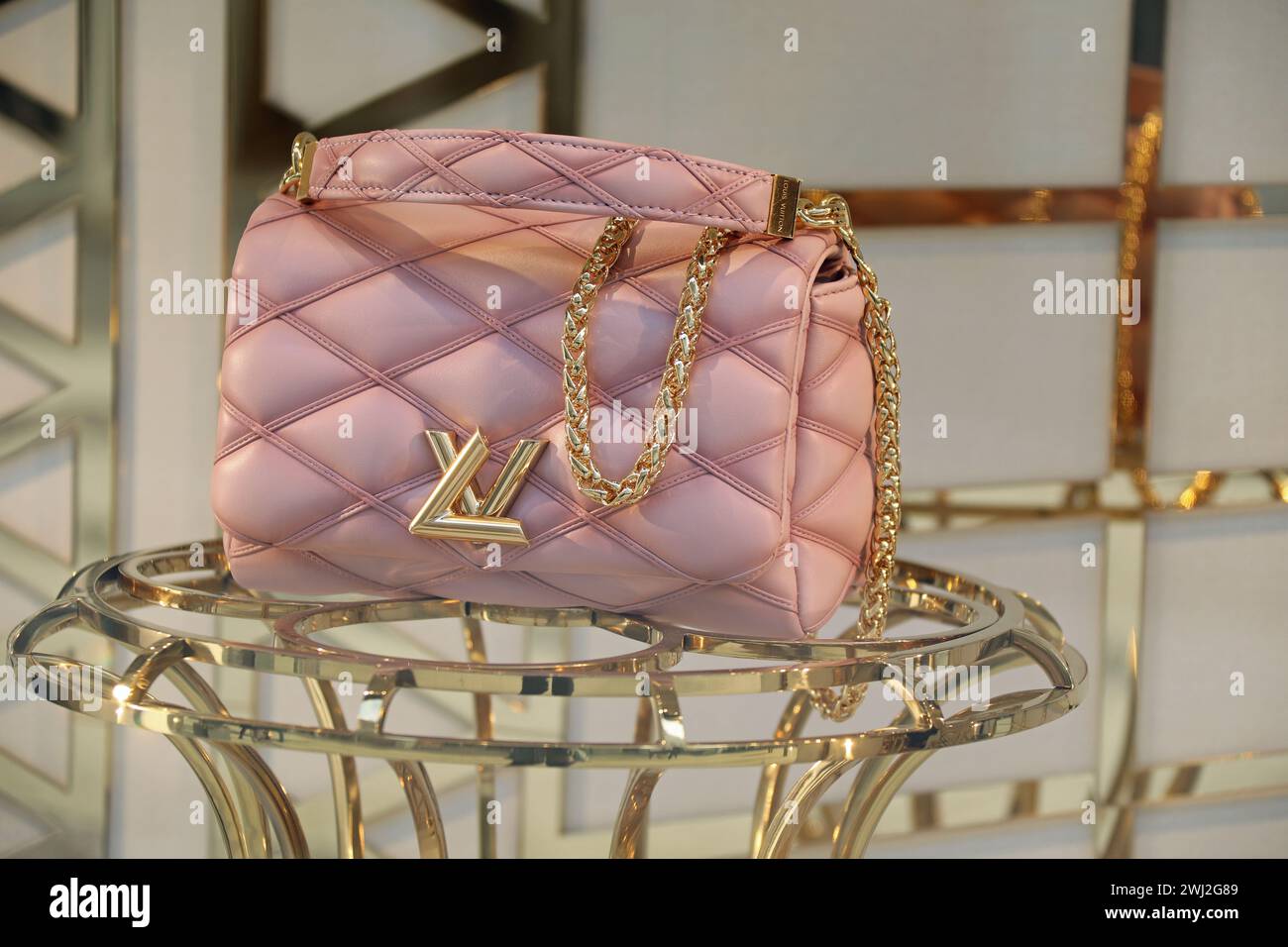 Powder pink Louis Vuitton bag in a shop window Stock Photo