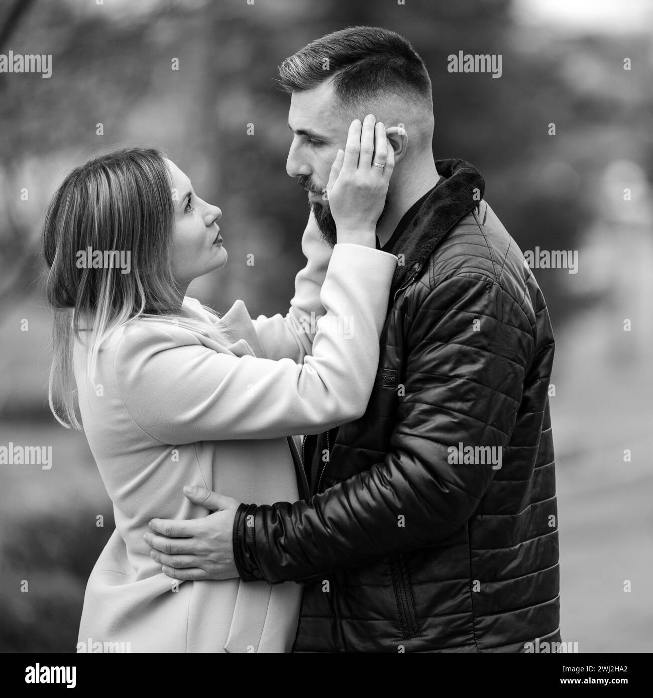 Portrait of a man and a woman in an autumn black and white park, a couple in love in the park. Stock Photo