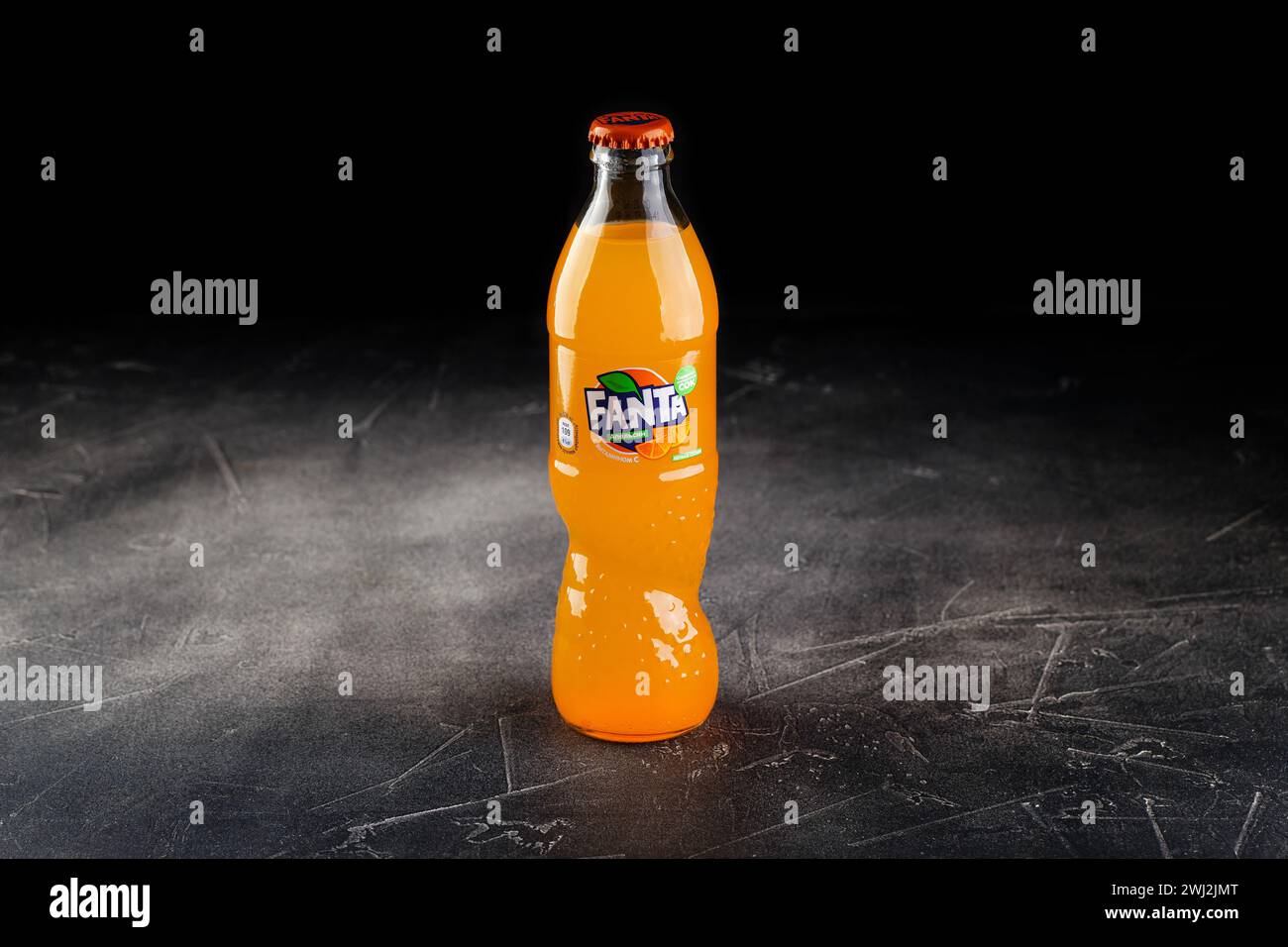 Glass bottle of Coca Cola company soft drink Fanta Orange. Stock Photo