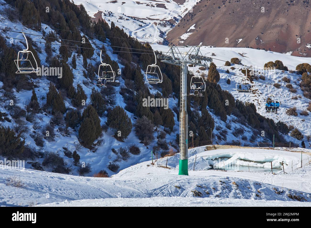 People goes up on ski lift, leading to the top of mountain slope ...