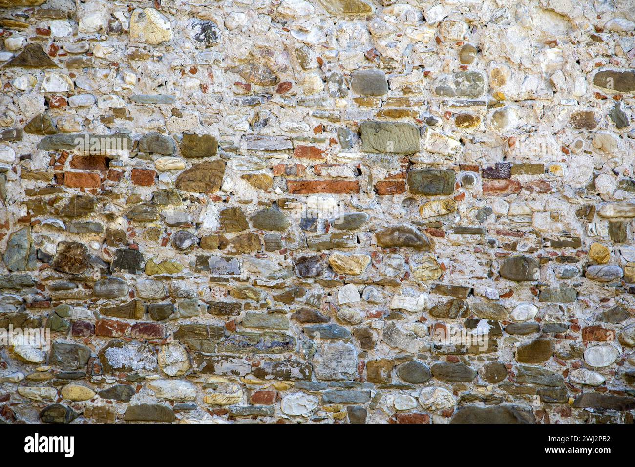 old painted brick wall, weathered and distressed paint peeling Stock Photo