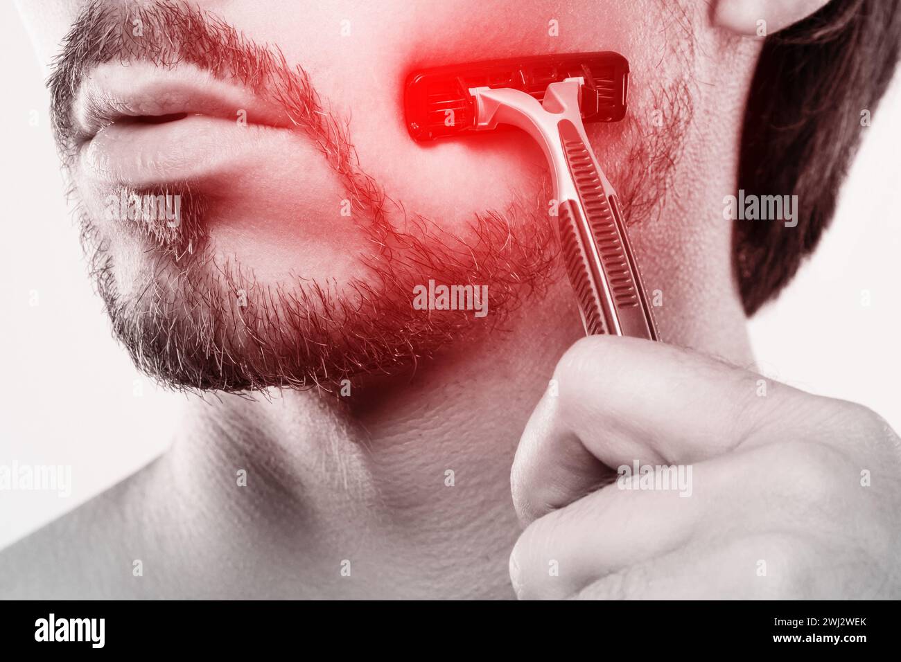 Man with sensitive skin during shaving routine Stock Photo