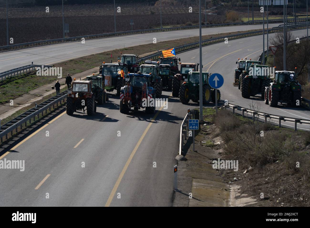 February, 12, 2024 Soses, Spainpol New protest by Catalan farmers, this time blocking the entry to Catalonia from Aragon at ap-2, in Soses. Tension with the police has been escalating as the blockade was not authorized. The Mossos d'Esquadra (Catalan police) have deployed riot vans and helicopters. They demand that their demands be heard and that the pressure does not decrease. They are also preparing blockades at the port of Tarragona and at the wholesale market in Barcelona. Nueva protesta de los agricultores catalanes, esta vez bloqueando la entrada a Catalu&#xf1;a desde Aragón, en Sos Stock Photo