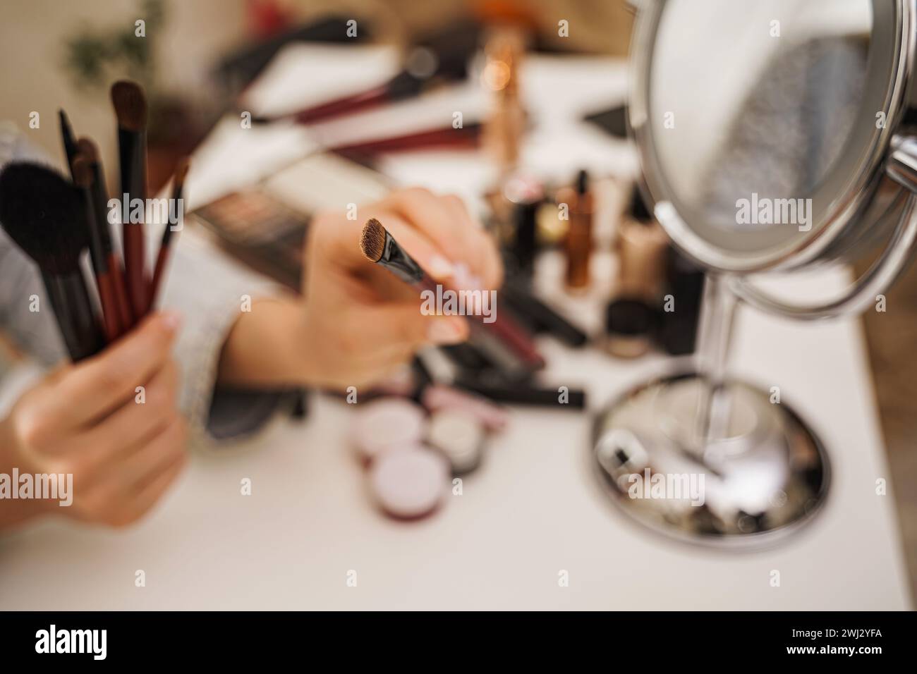 Female hands with makeup brushes Stock Photo