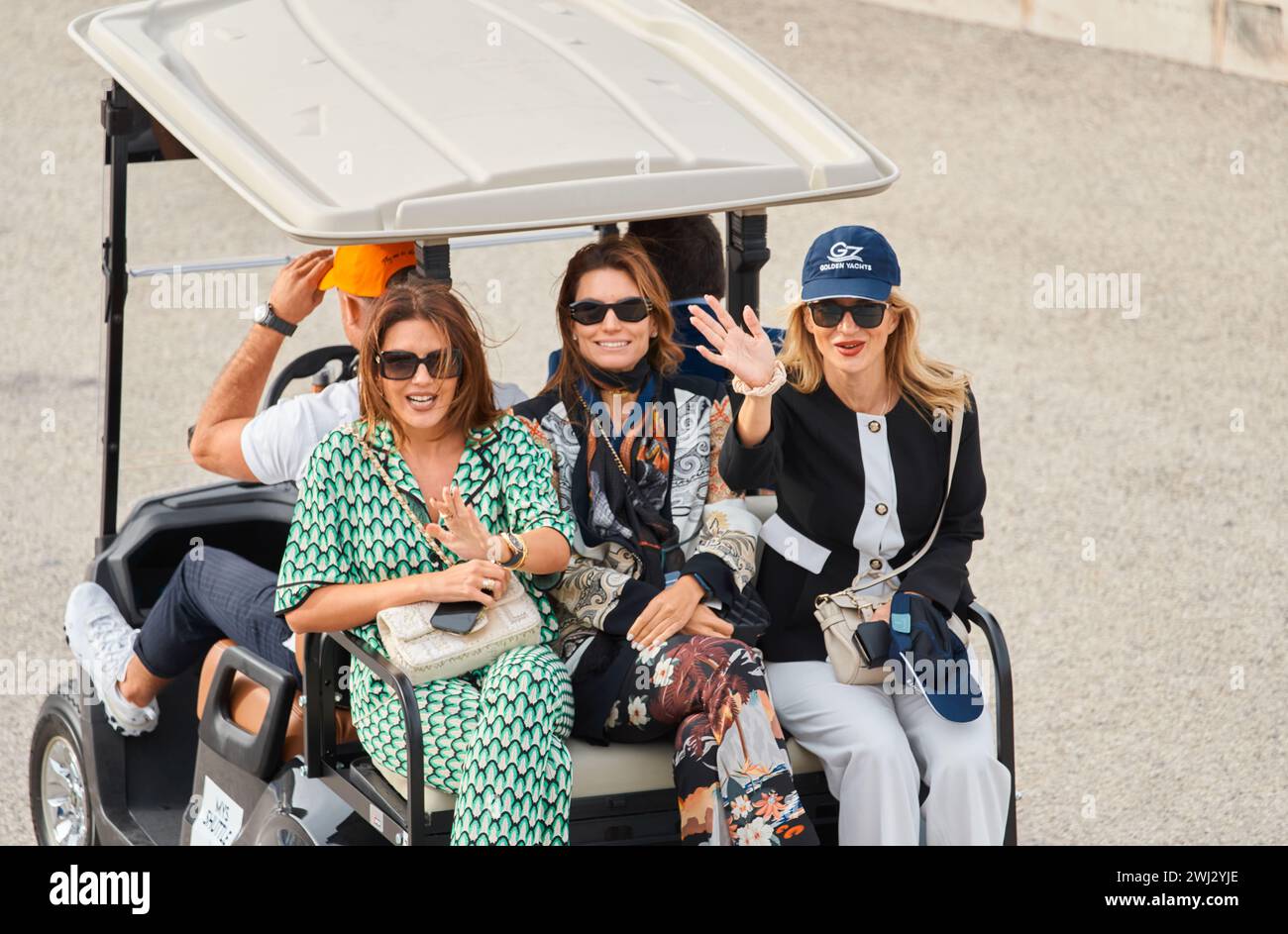 Monaco, Monte Carlo, 29 September 2022 - several beautiful women are riding in an electric car at the famous motorboat exhibition, mega yacht show Stock Photo