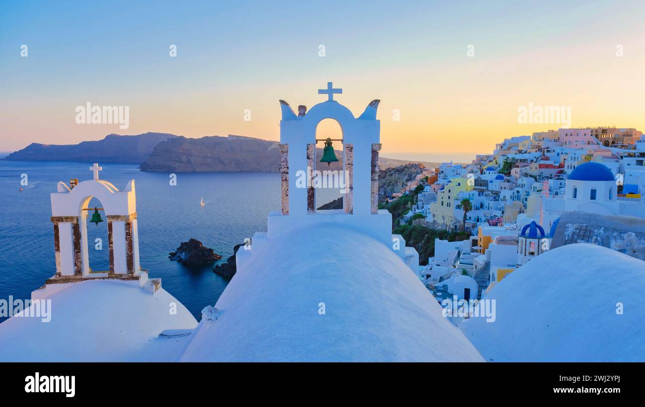 White churches an blue domes by the ocean of Oia Santorini Greece, traditional Greek village Stock Photo