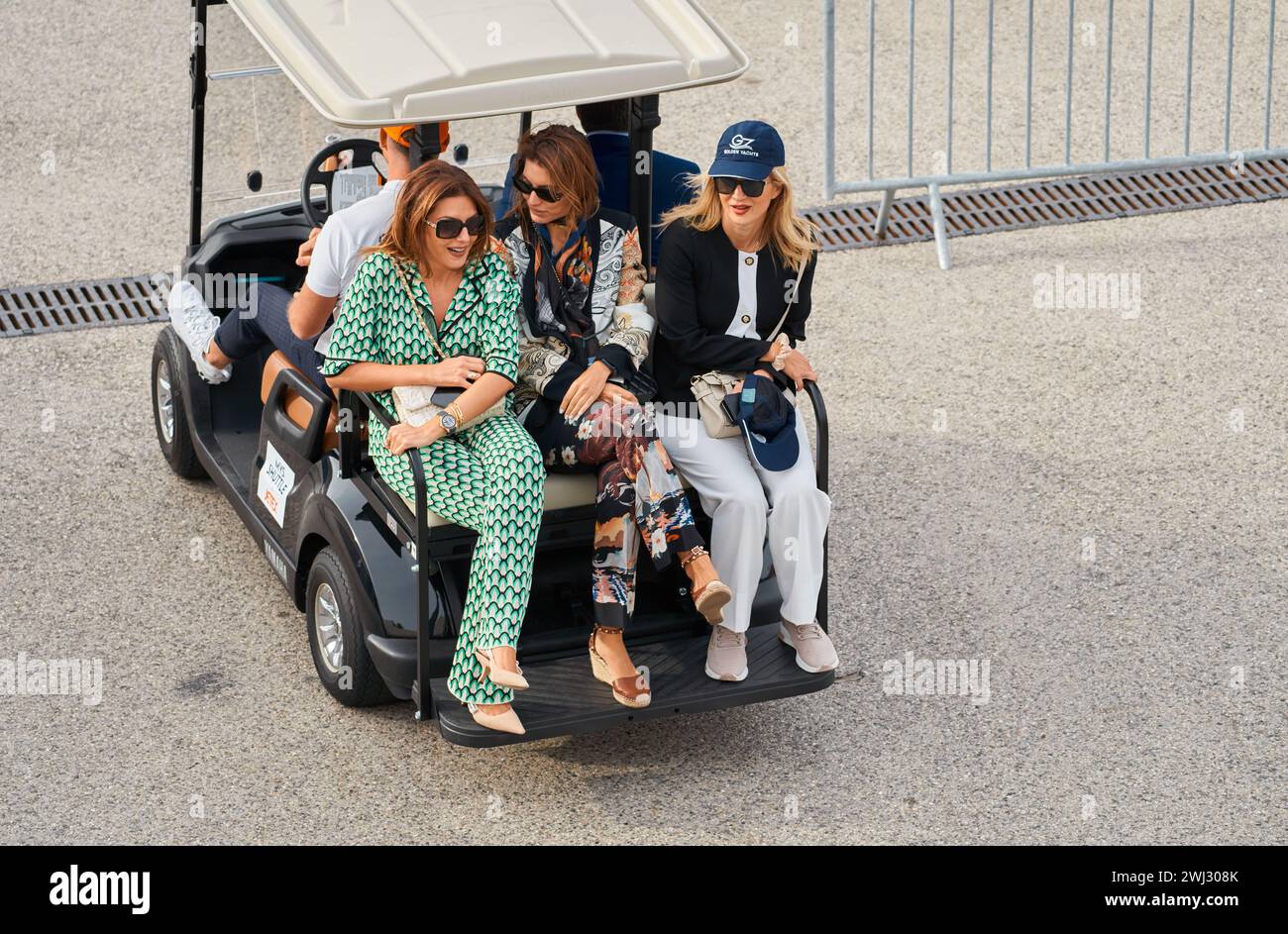 Monaco, Monte Carlo, 29 September 2022 - several beautiful women are riding in an electric car at the famous motorboat exhibition, mega yacht show Stock Photo