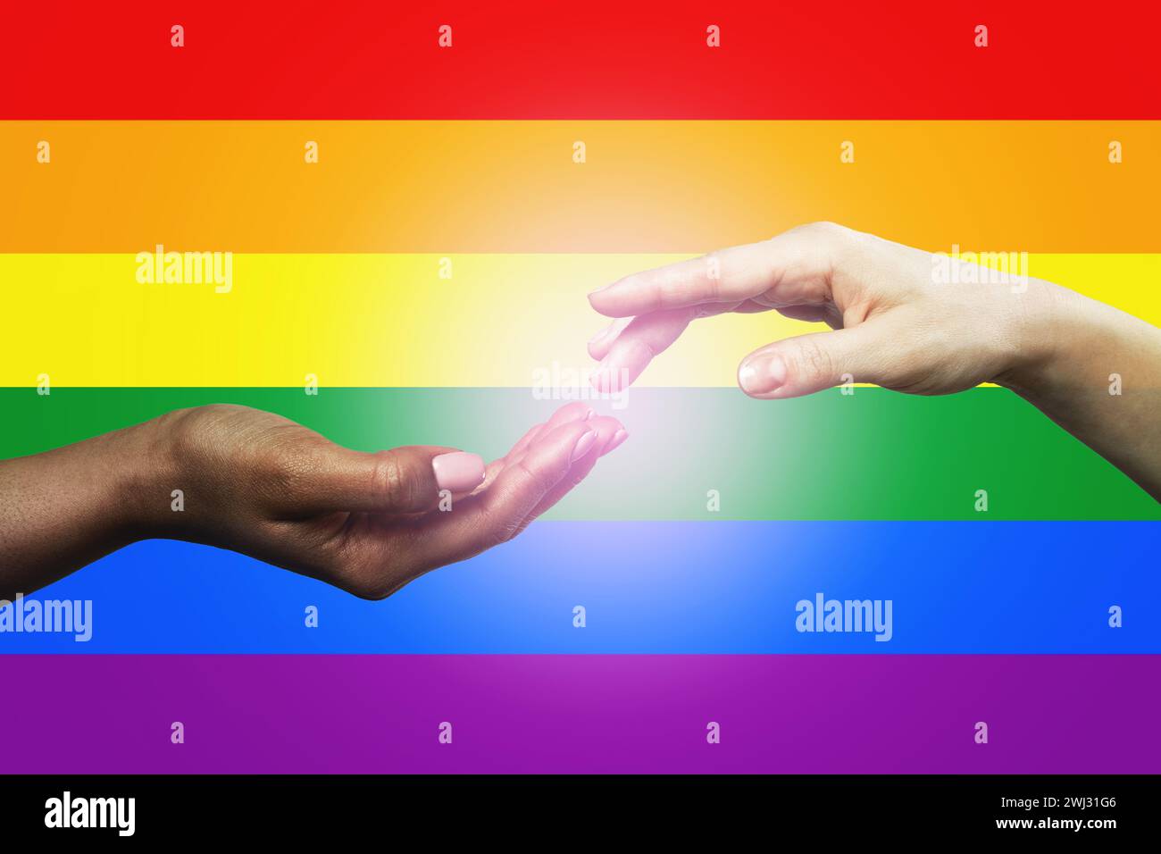 Female hands of diverse races against LGBT community flag Stock Photo