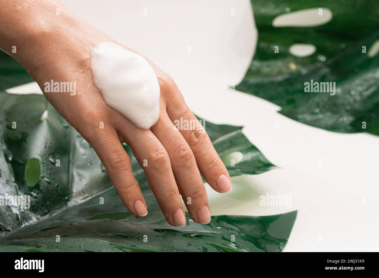 Closeup of female hand with a cleansing foam Stock Photo