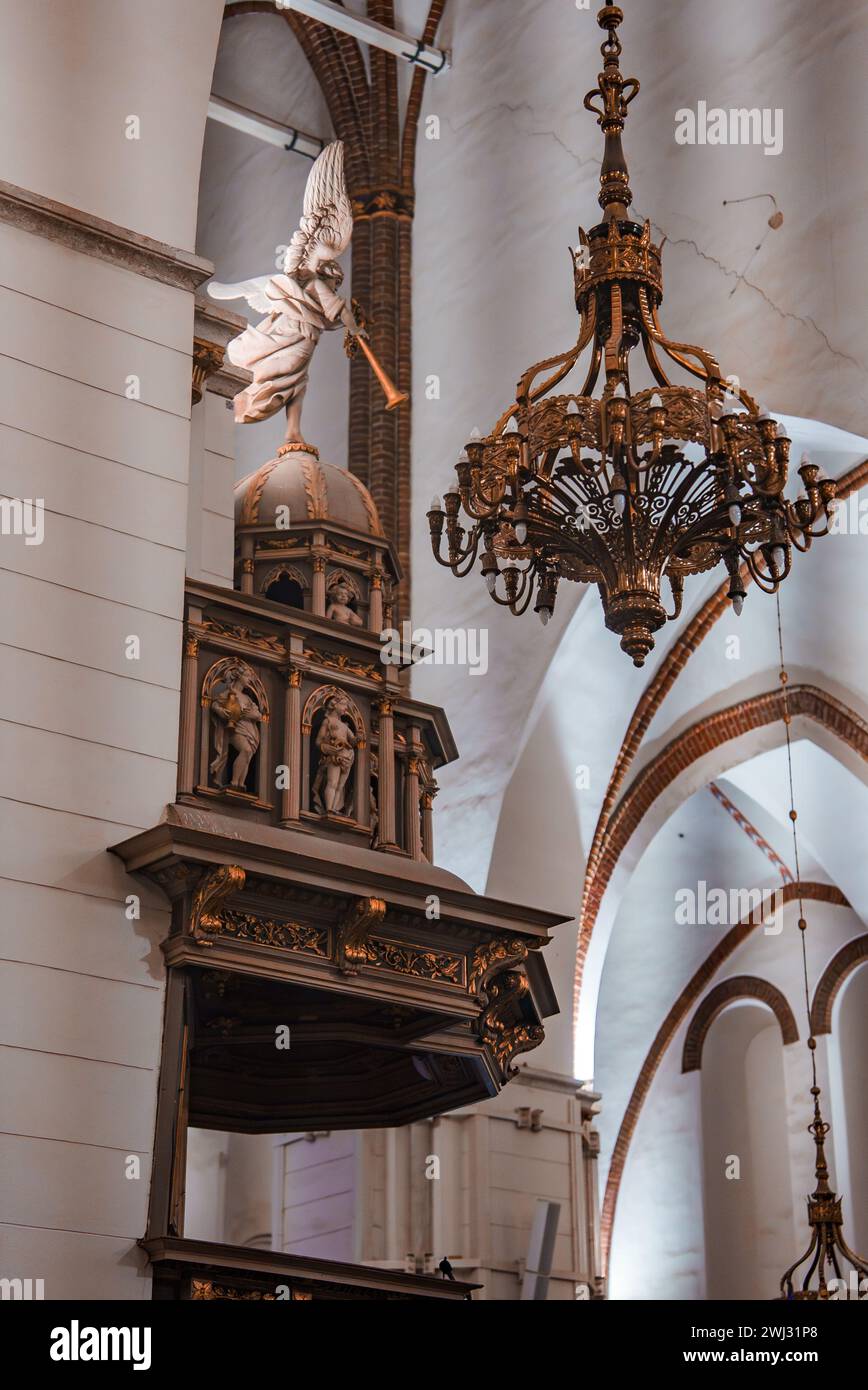 Inside a Gothic Church View of Pulpit and Chandelier in Latvia Stock Photo