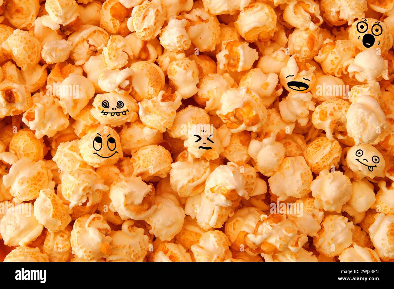 Hoax symbol. funny smiling popcorn background. detailed close-up of Scattered caramel popcorn, textu Stock Photo