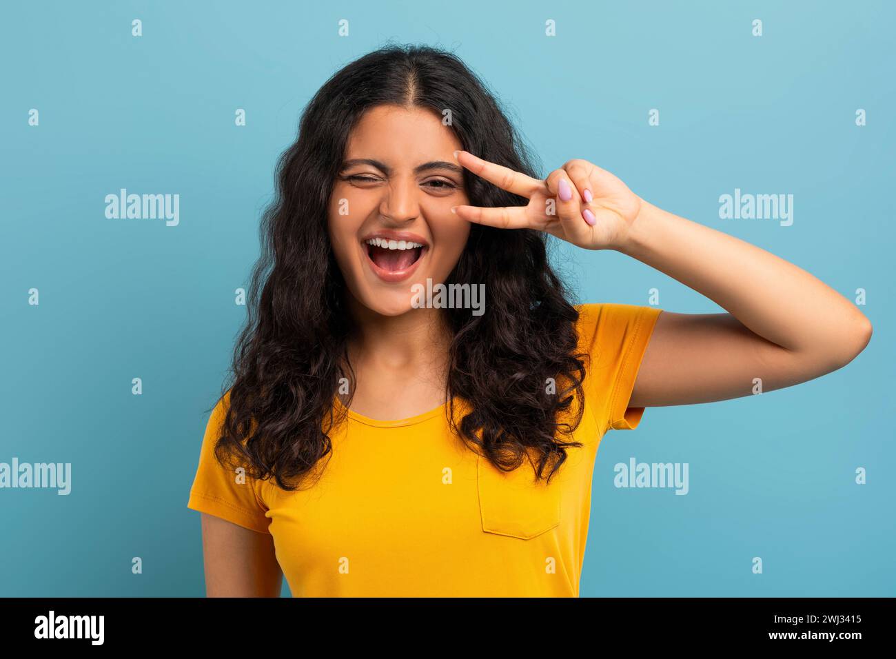 Cute playful young indian woman winking and gesturing Stock Photo - Alamy