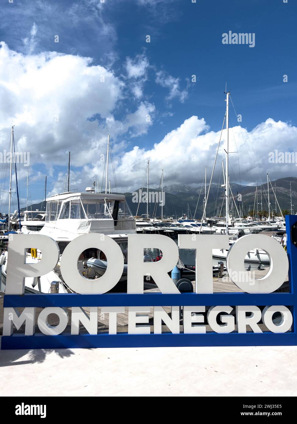 Tivat, Montenegro - 11 august 2023: Sign on the shore near the yachts. Caption: Porto, Montenegro Stock Photo