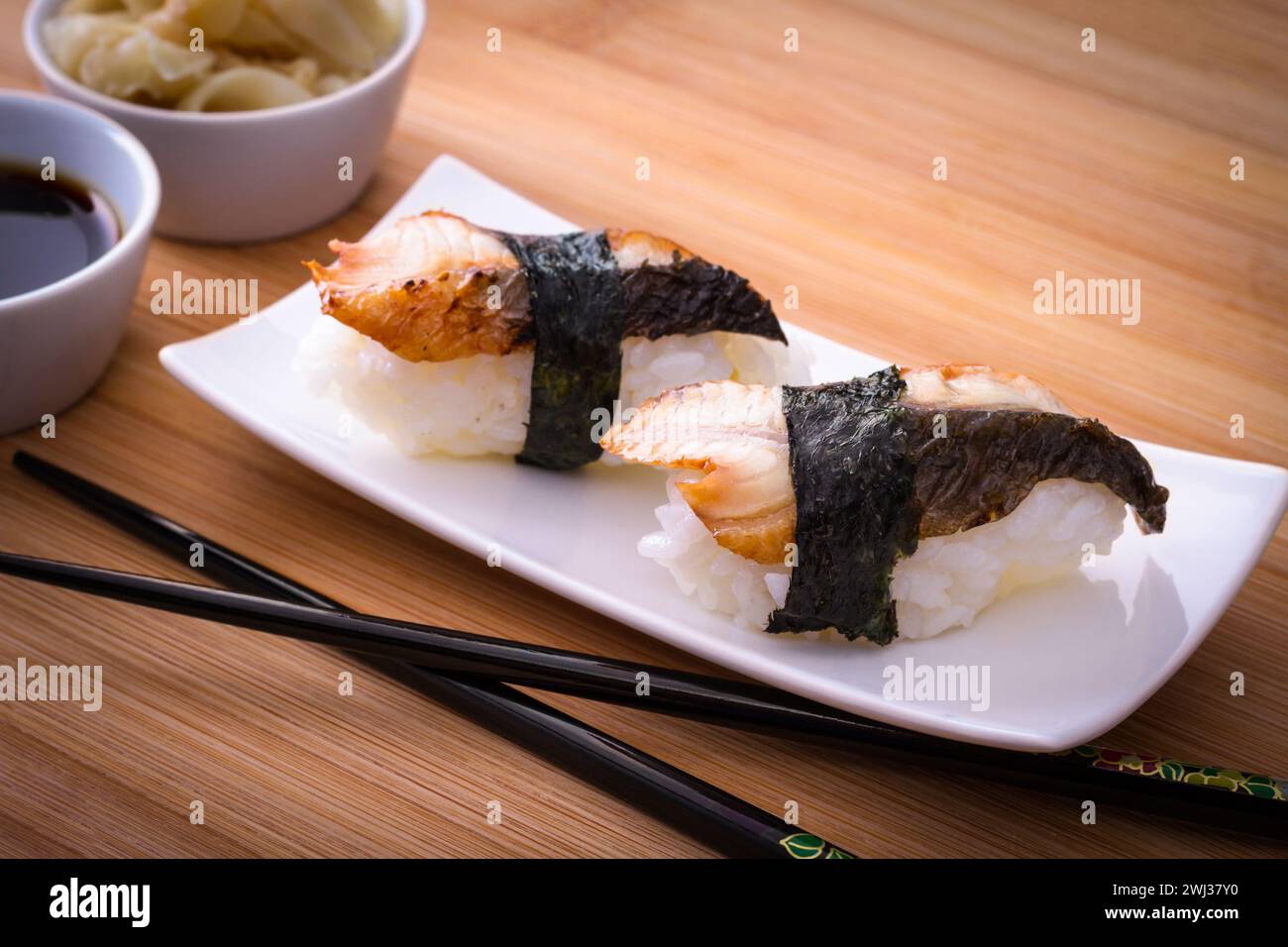 Two nigiri eel sushi on bamboo table Stock Photo