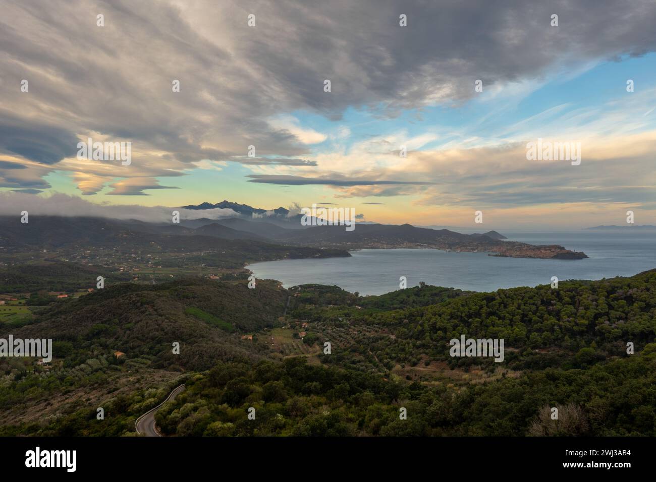 View of curvy mountain road and Portoferraio Bay on Elba Island at sunrise Stock Photo