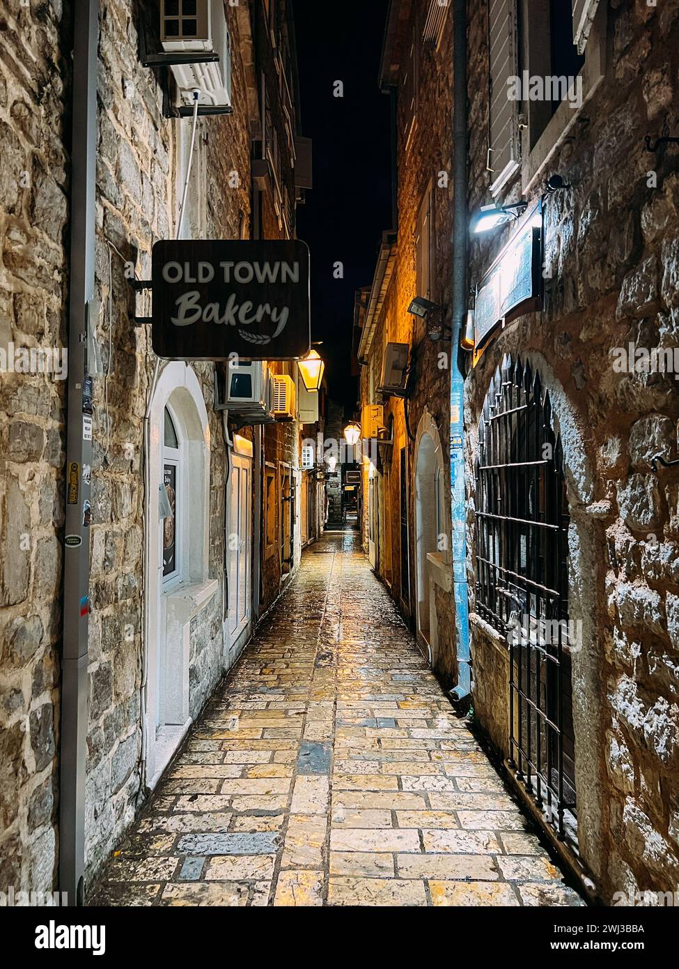Budva, Montenegro - 25 december 2022: Signboard on a narrow street with stone houses. Caption: Old Town Bakery Stock Photo