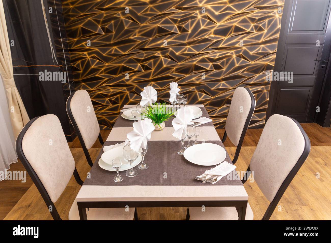 Table set up for four persons in a cafe, cafeteria, restaurant. Table and four chairs stand in corner of room. Empty seats for visitors. A place for a Stock Photo