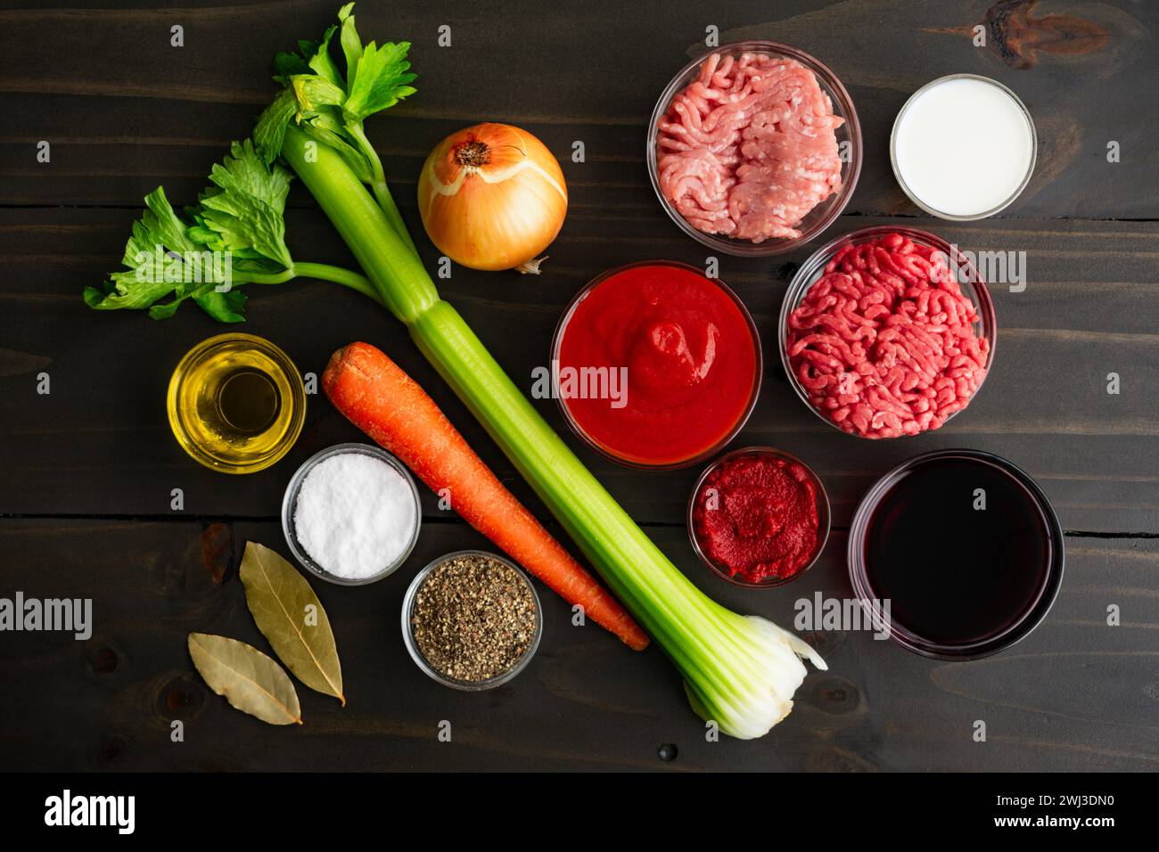 Bolognese Sauce Ingredients on a Rustic Wood Table: Passata, ground meat, and other ingredients for authentic ragu alla bolognese Stock Photo