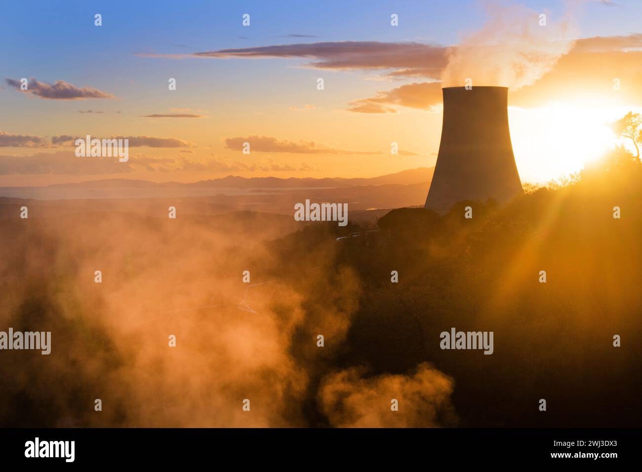 Photographic view of the steam cooling chimney at sunset Stock Photo