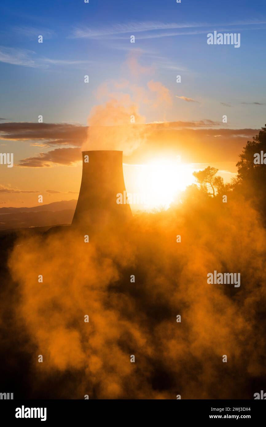 Photographic view of the steam cooling chimney at sunset Stock Photo