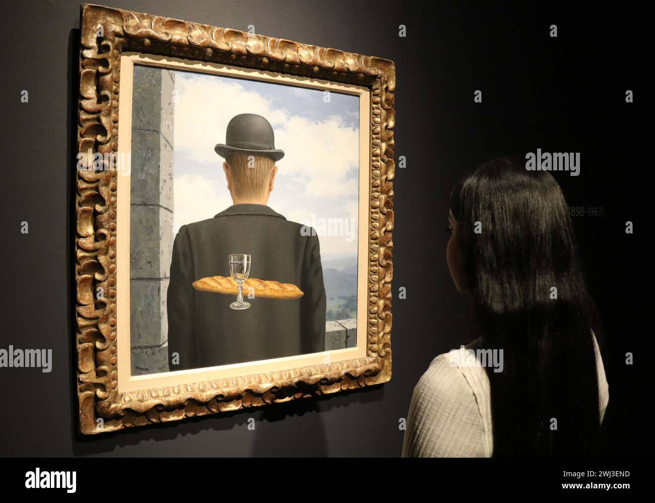 New York, New York, USA. 12th Feb, 2024. A woman views artist Rene Magritte's ''˜L'ami intime' (The Intimate Friend), painted in January - February 1958, seen on display at Christie's Rockefeller Center, as part of London Highlights ''˜The Art of the Surreal Evening Sale.' The high estimate the painting is expected to sell for is $50 million - $63 million dollars. (Credit Image: © Nancy Kaszerman/ZUMA Press Wire) EDITORIAL USAGE ONLY! Not for Commercial USAGE! Stock Photo