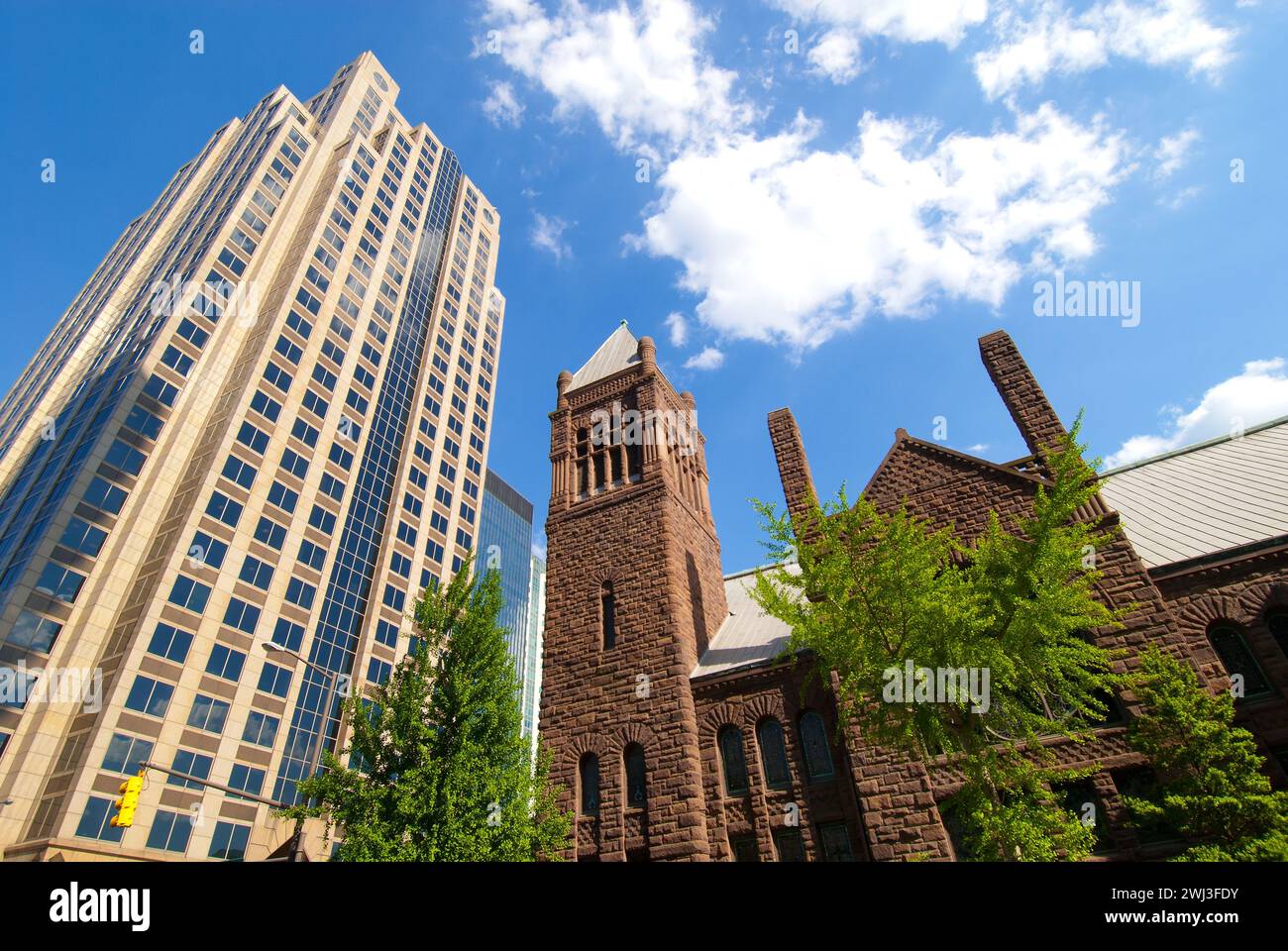 First United Methodist Church, built 1891, dwarfed by financial office towers in city center of Birmingham, Alabama - USA Stock Photo