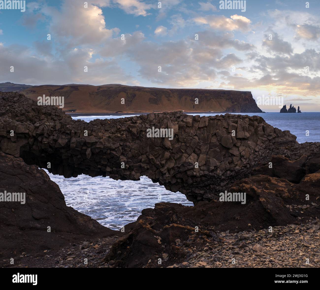 Picturesque autumn evening view to Reynisfjara ocean  black volcanic sand beach and rock formations from Dyrholaey Cape, Vik, So Stock Photo