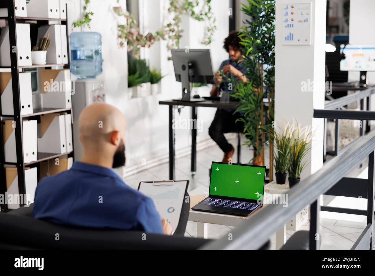 Corporate Work Using Computer Executive analyzing reports, developing strategy and using laptop with ...