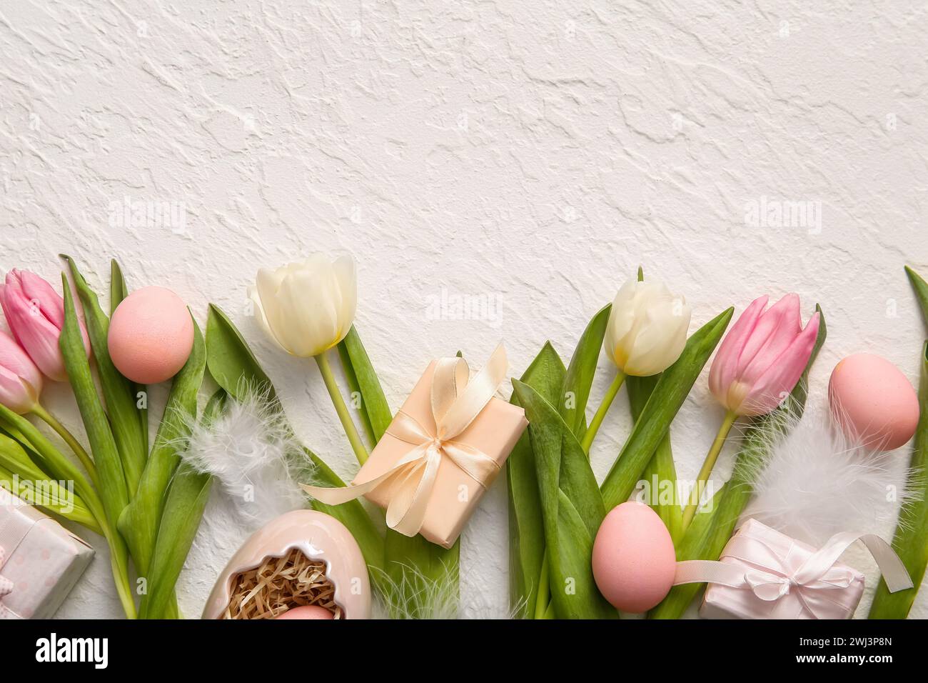 Easter eggs with gift boxes and tulip flowers on white background Stock ...