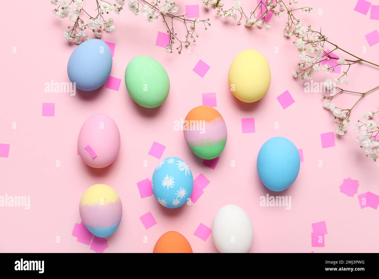 Composition with painted Easter eggs, gypsophila flowers and confetti ...