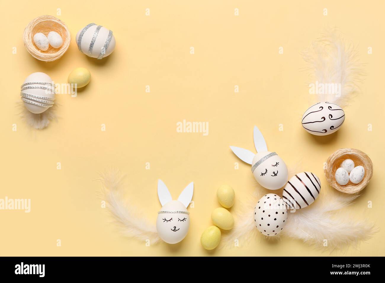 Composition with different creative Easter eggs and feathers on beige background Stock Photo