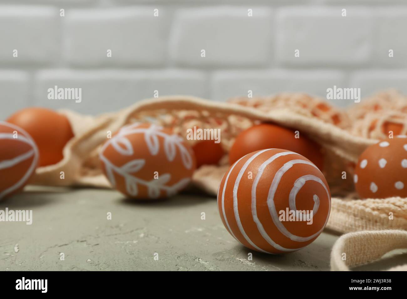String bag with painted Easter eggs on grey table Stock Photo