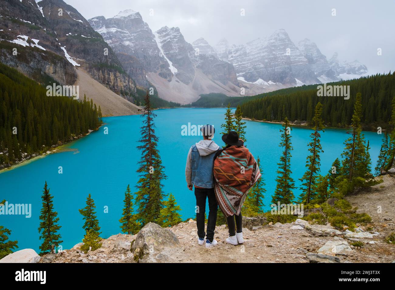 Lake moraine during a cold snowy day in Canada, turquoise waters of the Moraine lake with snow Stock Photo