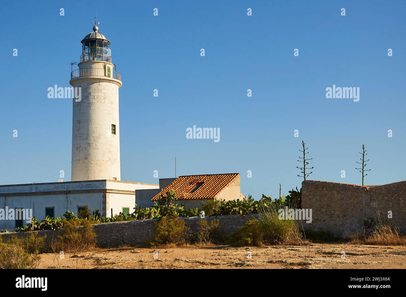 Far de La Mola lighthouse located in Punta des Far cape on a clear day (Formentera, Pityusic Islands, Balearic Islands, Mediterranean sea, Spain) Stock Photo