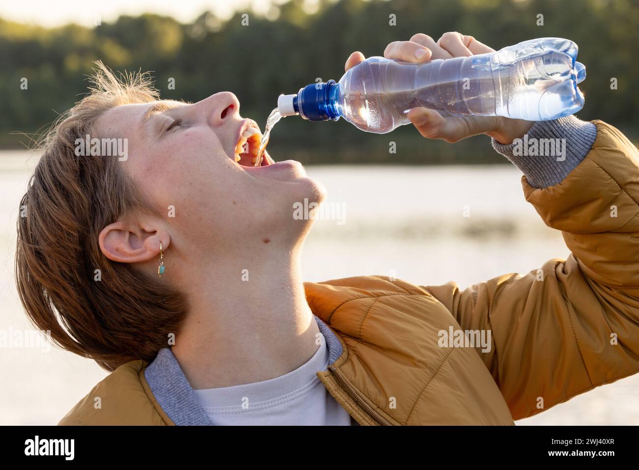 Refreshment by the Lake: Quenching Thirst in Nature Stock Photo