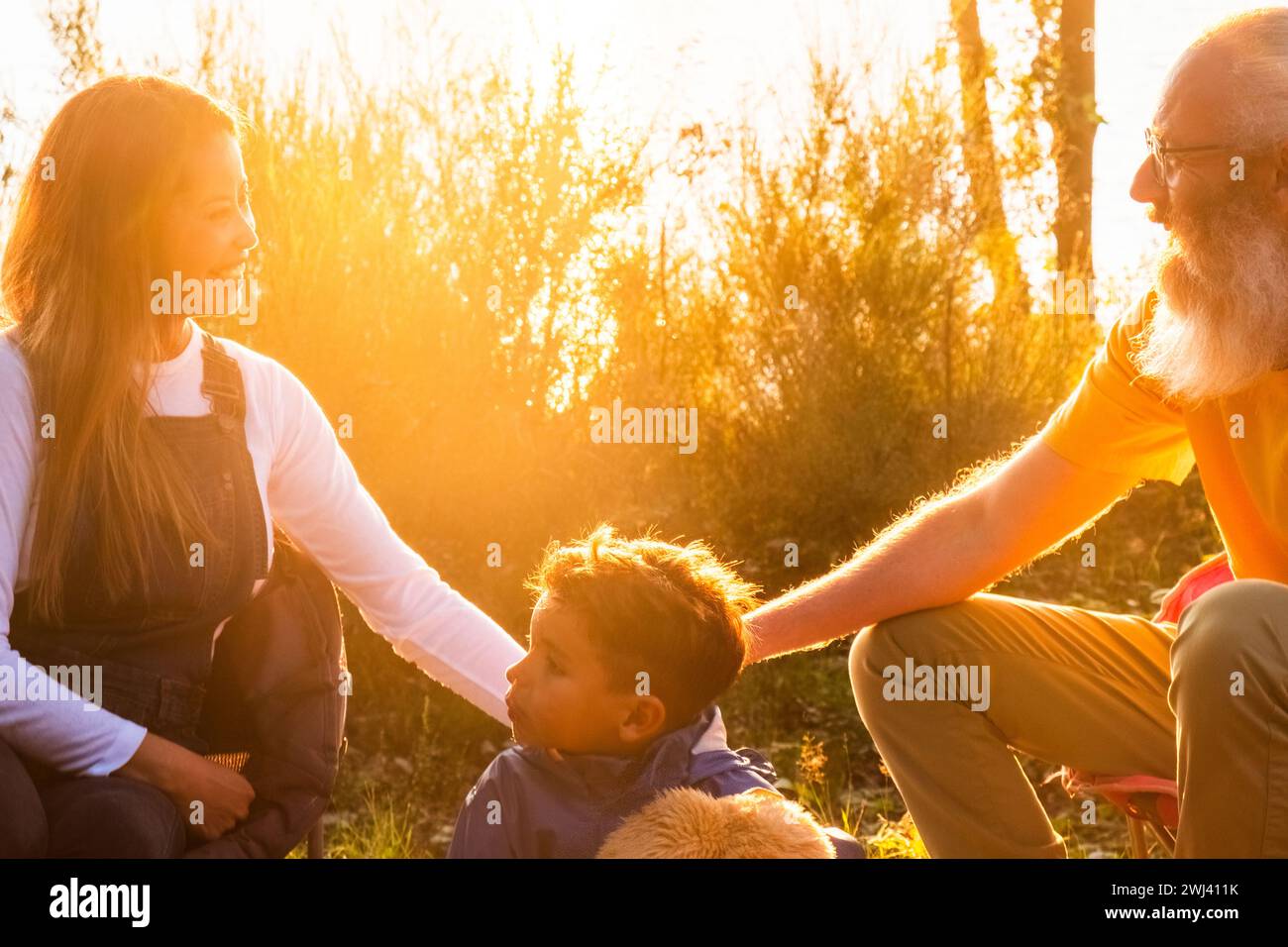 Generational Bonding: A Peaceful Family Moment in Nature Stock Photo