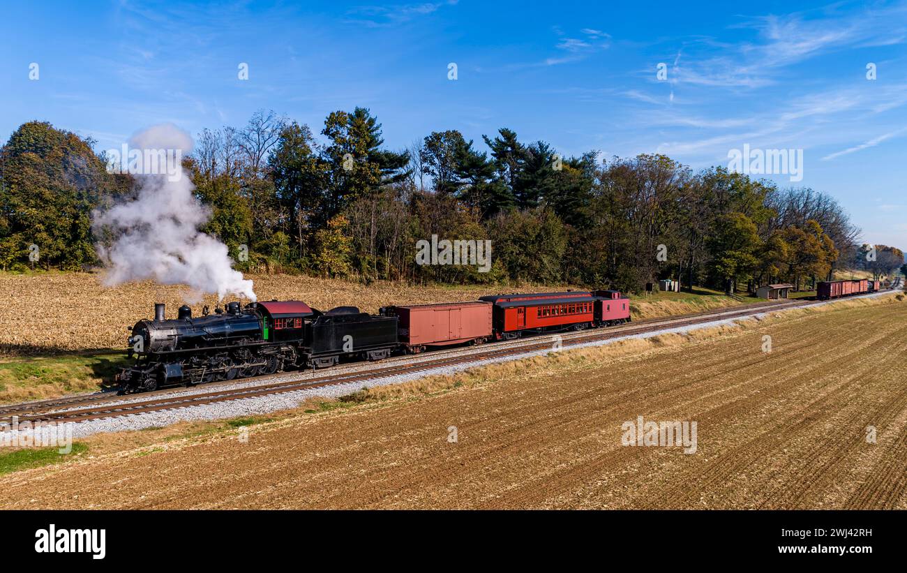 Aerial View of an Antique Restored Steam Passenger - Freight Train Traveling Thru Farmlands on a Autumn Day Stock Photo