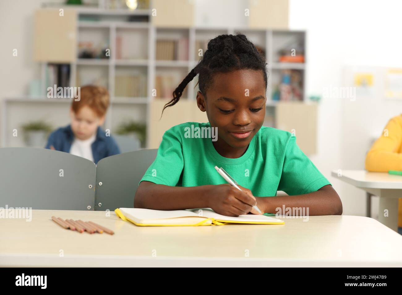 Cute little boy studying in classroom at school Stock Photo - Alamy