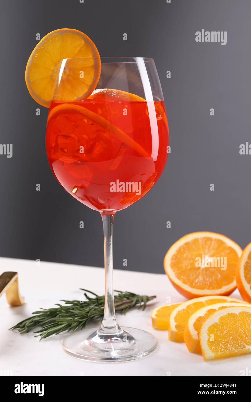 Glass of tasty Aperol spritz cocktail with orange slices and rosemary ...