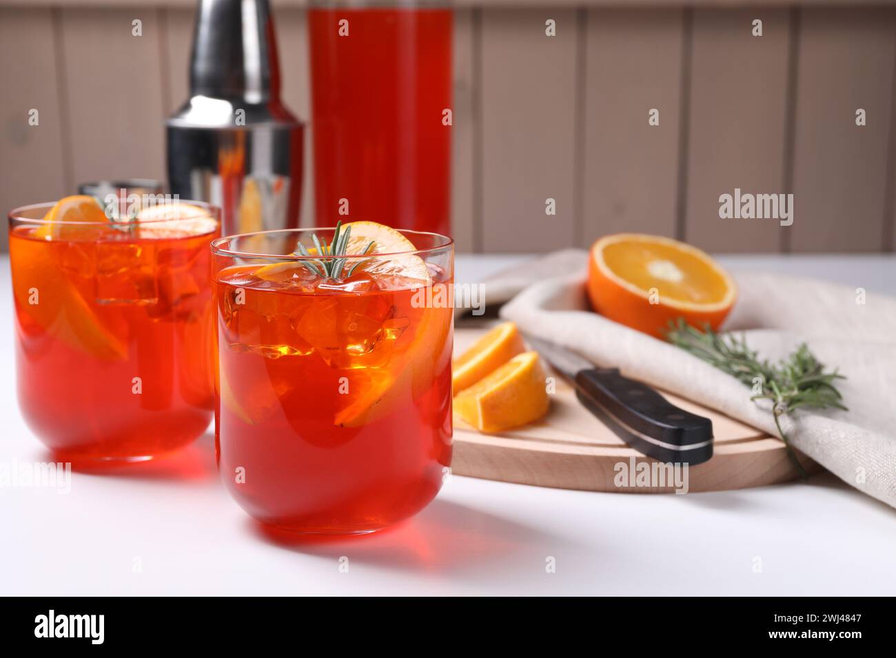Aperol spritz cocktail, rosemary and orange slices on white wooden ...